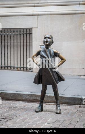 NEW YORK, USA-JULY 29, 2023: Fearless Girl - bronze sculpture by Kristen Visbal across from the New York Stock Exchange Building Stock Photo