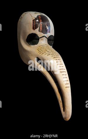 Close-up of Italian bird-like beak mask for plague doctor to treat victims of bubonic plague during epidemic, made of papier-mâché on black background Stock Photo