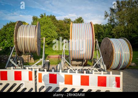 large reels with fiber optic cables stand on a square Stock Photo