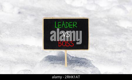 Boss vs leader symbol. Concept words Boss vs versus leader on beautiful black chalk blackboard. Beautiful snow background. Business motivational boss Stock Photo