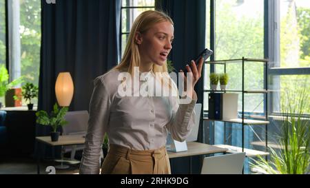 Annoyed mad angry businesswoman employer manager woman Caucasian girl talk mobile phone in office arguing business conversation stress trouble problem Stock Photo