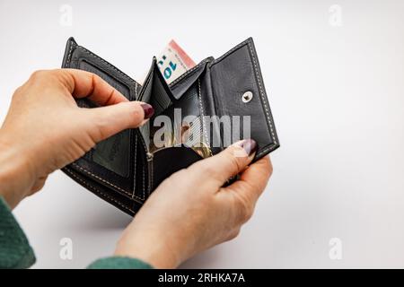 Empty purse with spare change symbolizing living from hand to mouth in Europe in inflation Stock Photo