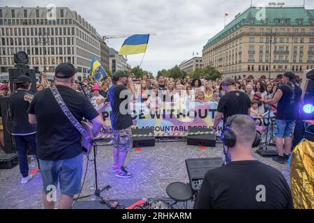 August 17, 2023, Berlin, Germany: On August 17, 2023, the Brandenburg Gate, a symbol of unity and peace, became the backdrop for a powerful demonstration of solidarity and resistance. Ukrainian hip-hop pioneers, TNMK (Tanok na Maidani Kongo), took to the stage in a charity concert that was as much a musical extravaganza as a political statement. The evening was charged with emotion as Ukrainians gathered, many waving Ukrainian flags, to support the cause of Ukraine's freedom. The air was thick with chants of ''Russia is a terrorist state, '' a sentiment echoed by many in attendance. A massive  Stock Photo