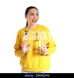 Young woman with bottles of vodka on white background Stock Photo