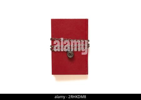 Red book on a chain under lock and key on a white background close-up Stock Photo