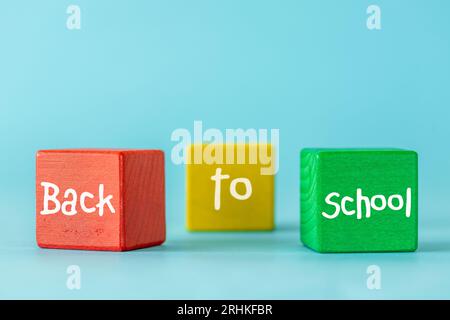 Back to school words written on colorful blocks, Beautiful blue background, Positive education concept Stock Photo