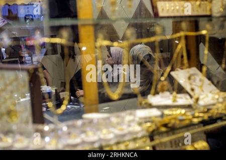 Palestinians shop at the gold market in the old Gaza market in the east ...