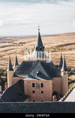 Alcazar of Segovia fairy-tale towers, Spanish Gothic architecture watchtowers with fields in the background, Spain. Stock Photo