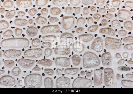 Stone facade of the Alcazar of Segovia, Spain, round stones built in the wall facade with small black stones in between. Stock Photo