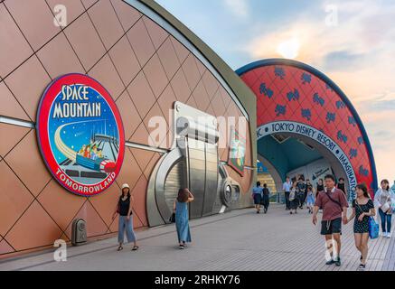 chiba, japan - july 18 2023: People crossing walkway to Tokyo Disney Resort along the walls of Bon Voyage shop decorated with Space Mountain Stock Photo