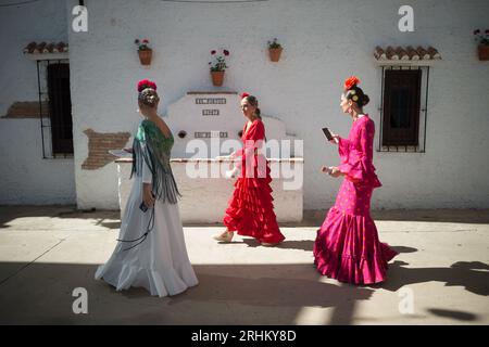 Malaga Spain. 17th Aug 2023. Women wearing flamenco dresses are seen walking as they take part in the 2023 Malaga Fair. Thousands of people gathered in the city s main streets to take part in the Mala...