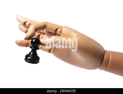 Robot with pawn isolated on white. Wooden hand representing artificial intelligence playing chess Stock Photo