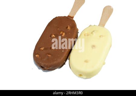 Rich vanilla flavored ice creams in cracking brown and white milk chocolate and roasted almond, Vanilla ice cream sticks coated and covered with a lay Stock Photo