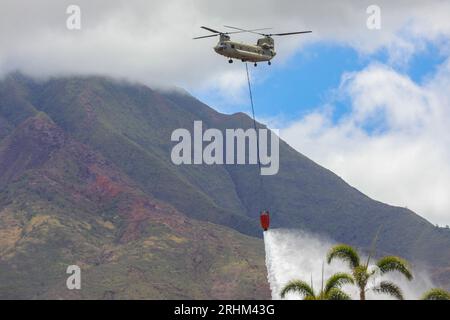 Lahaina, Maui, on August 16, 2023. A U.S. Army CH-47 Chinook fills a bucket with seawater to drop around the perimeter of the area impacted by the wildfires at Lahaina, Maui, on August 16, 2023. Members of Joint Task Force 50 (JTF-50) from the Hawaii Army and Air National Guard, U.S. Army Active Duty and Reserve are actively supporting Maui County authorities to provide immediate security, safety, and well-being to those affected by the wildfires to ensure unwavering support for the community of Maui and first responders. Photo by Spc. Tonia Ciancanelli/U.S. Army National Guard/UPI Stock Photo