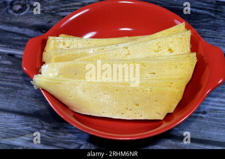 Slices of Egyptian Rumi cheese, also called gebna romiya or gebna turkiya, Roumi, Romi also Romy, middle Eastern parmesan hard cheese, has a pungent s Stock Photo