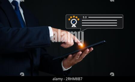 Businessman holding tablet and analyzing customer segments from application. customer satisfaction survey Service experience rating online application Stock Photo