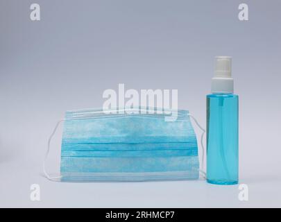 Mask and Alcohol Gel Sanitizer. Hand sanitizer for anti bacteria and virus on white background. People who use alcohol gel to wash their hands to prev Stock Photo