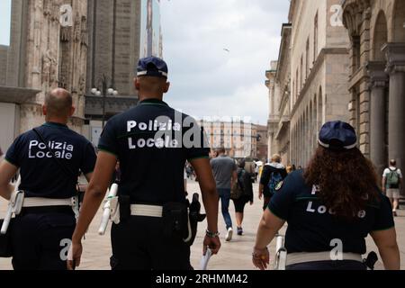 Milan , Italy  - 08 17 2023 : polizia locale police policemen in street police italian patrol in town street Stock Photo