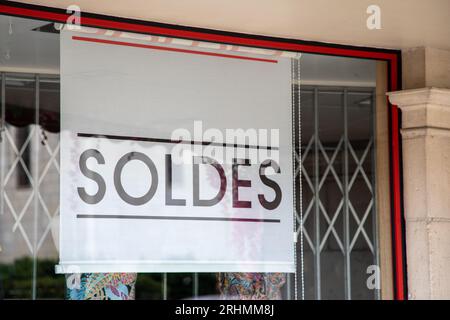 Premium Photo  Soldes french text means sale sign in clothing store on  rack display