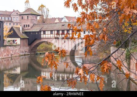 Nuremberg Altstadt landmark. Medieval houses and Henkersteg bridge over Pegnitz river. Old town of Nuremberg, Germany. Autumn landscape in old town. Stock Photo