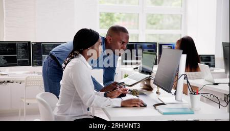 African Business Team Working On Computer. Software App Development Stock Photo