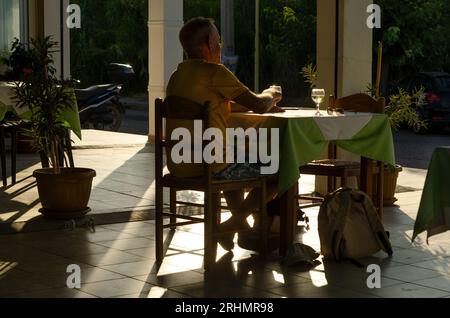 An unrecognizable man in restaurant in Rhodes in Greece Stock Photo