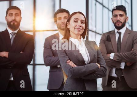 Happy diverse business people office workers team standing in row looking at camera. Stock Photo