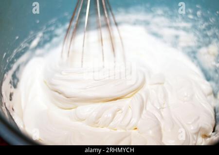 Mixing Whipped Cream in a Stand Mixer with a Whisk Attachment: Heavy  whipping cream mixed with a stand mixer wire whisk Stock Photo - Alamy