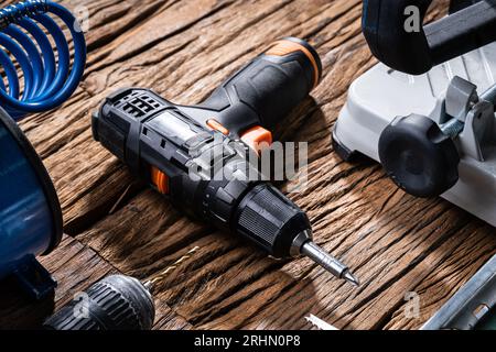 Various Power Tools Laying On Wooden Desk Stock Photo