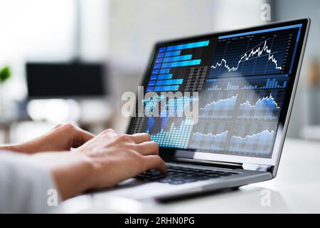 Close-up Of A Businesswoman's Hand Analyzing Graph On Laptop Stock Photo