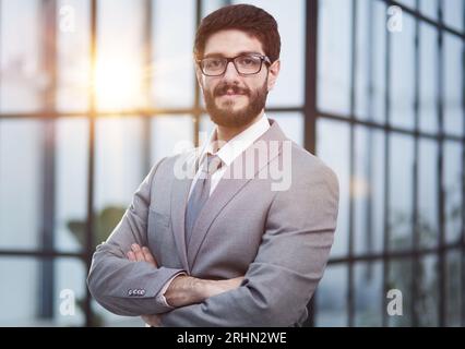Portrait of serious handsome successful businessman in glasses and suit. Stock Photo