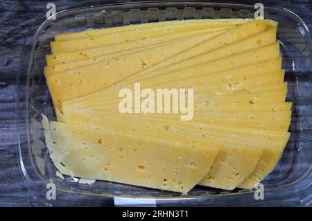 Slices of Egyptian Rumi cheese, also called gebna romiya or gebna turkiya, Roumi, Romi also Romy, middle Eastern parmesan hard cheese, has a pungent s Stock Photo