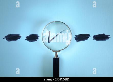 Magnifying glass enlarging the correct choice or check mark on blue background. Business concept,idea,right choice,quality control and Approval and Co Stock Photo