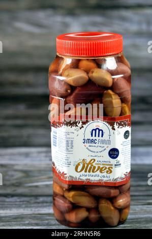 Cairo, Egypt, July 26 2023: 3 Mac farm whole olives kalamata, The Kalamata olive is a large, dark brown olive with a smooth, meaty texture, named afte Stock Photo