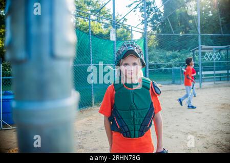 10 year old girl is the catcher on the little league team Stock Photo