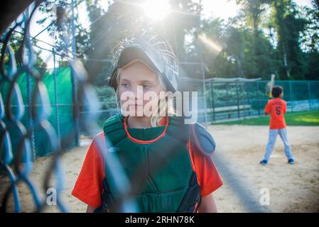 10 year old girl is the catcher on the little league team Stock Photo