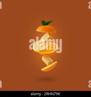 levitating sliced orange and lemon with cookies on a yellow back Stock Photo