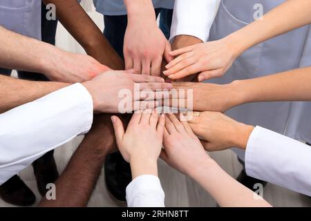 Directly Above Shot Of Medical Team Stacking Hands Together At Hospital Stock Photo