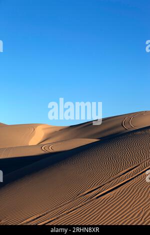 Sand dunes with wheel ruts and patterns in sand vertical Stock Photo ...