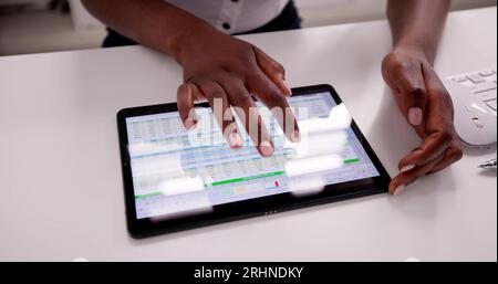 African American Spreadsheet Data Analyst Using Computer Software Stock Photo