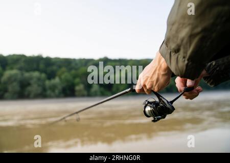 fisherman with tackle box and fishing rod Stock Photo - Alamy