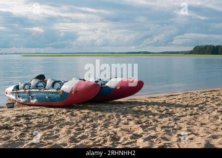 inflatable raft-catamaran for whitewater sports is moored on the river ...