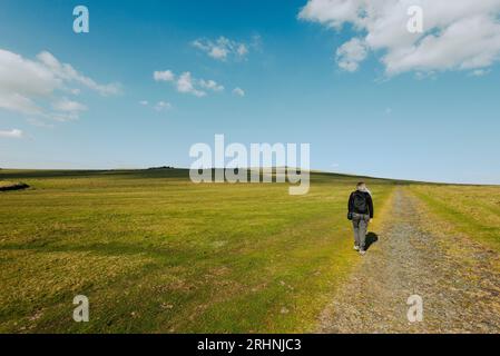 A middle aged woman enjoys a walk on Dartmoor National Park in good spring weather in April Stock Photo