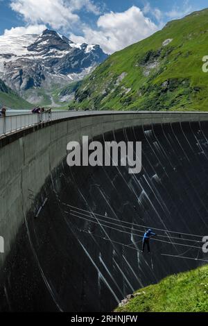 A man crossing a Via Ferrata course on the Mooserboden Dam, Kaprun Valley, Salzburgerland, Austria Stock Photo