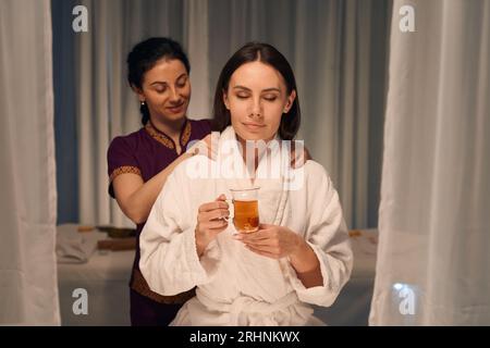 Female client enjoying massotherapy session in wellness center Stock Photo