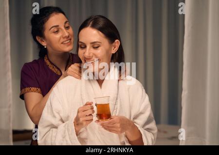 Wellness center client enjoying Thai massage therapy session Stock Photo