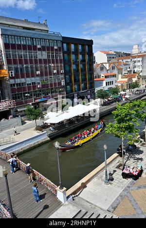 City Center Aveiro, canal and bridge with ribbons, tourist traditional Moliceiro boat and buildings, Portugal Stock Photo