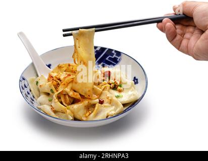 Pick up Biangbiang noodles with chopsticks, Chinese Shaanxi cuisine Stock Photo