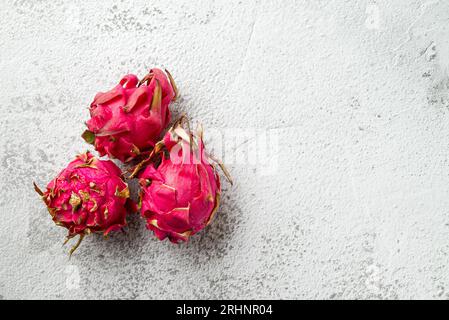 Ripe red dragon fruit on stone table Stock Photo