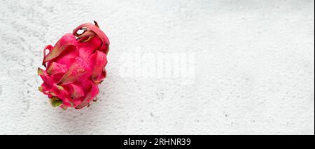 Ripe red dragon fruit on stone table Stock Photo